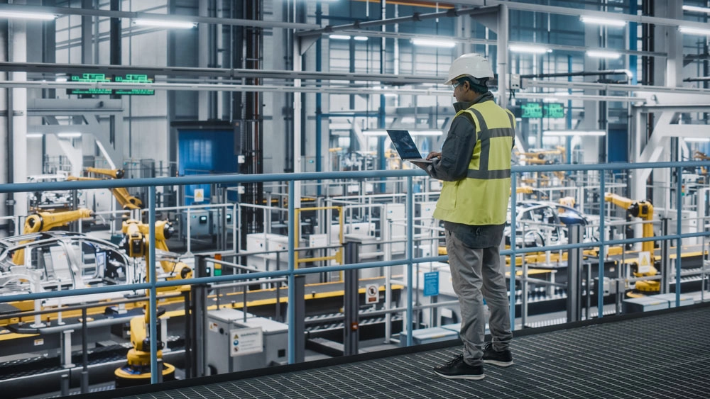 Industrial worker inspecting a production facility, highlighting how poor asset data can cause downtime, maintenance issues, and safety risks.