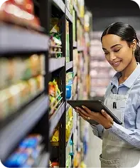 Retail worker using a tablet to manage products and inventory in a retail store.